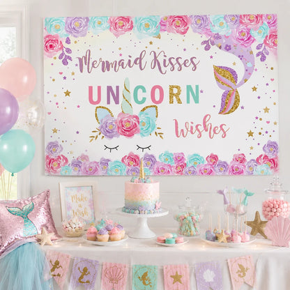 Pastel mermaid and unicorn birthday backdrop with colorful flowers, gold stars, unicorn horn and mermaid tail design.