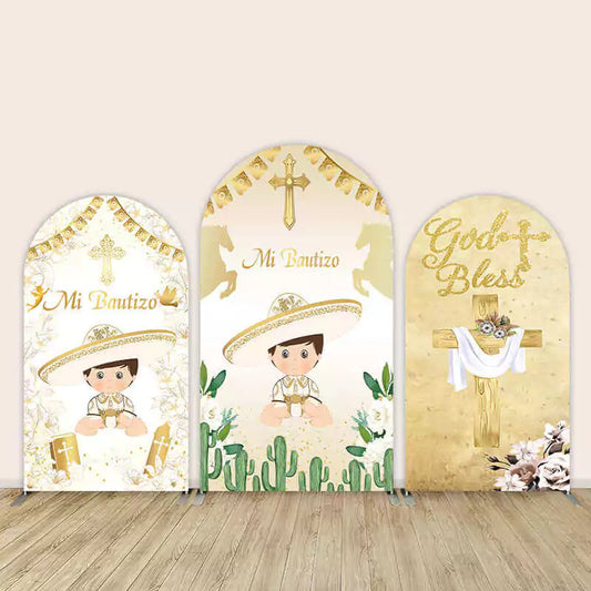 Three-panel Mi Bautizo arch backdrop featuring baby boy in Mexican attire with crosses, cacti, and gold religious themes, including “God Bless.”