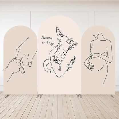 Three-panel minimalist baby shower arch backdrop with line drawings of pregnant woman, mother holding baby, and baby hand holding mom’s finger.