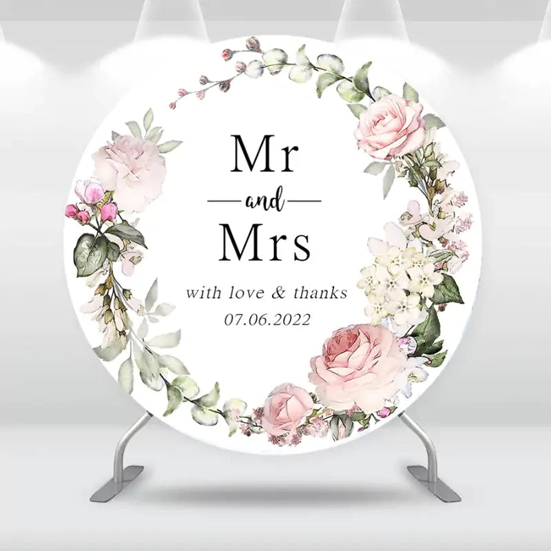 Custom round wedding backdrop with romantic floral accents and Mr and Mrs text.