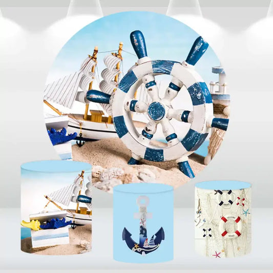 Nautical-themed round backdrop with a blue-and-white ship's wheel and matching cylindrical pedestal covers featuring anchors, sailboats, and maritime elements.