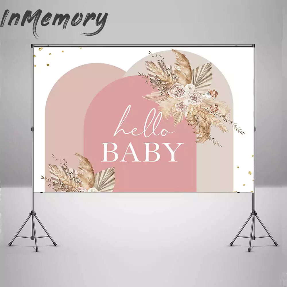 Blush and beige baby shower decoration with floral accents and modern arch design.