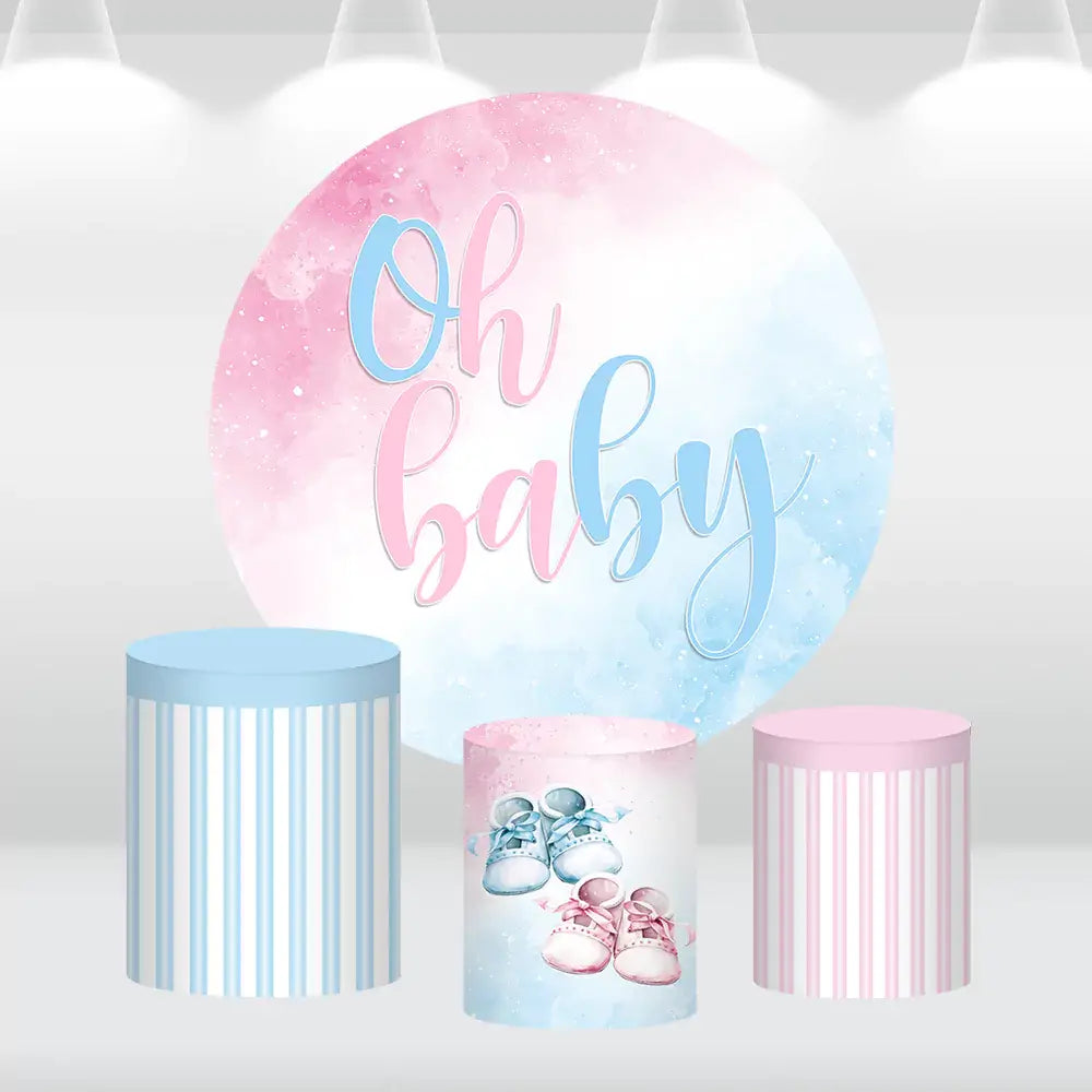 Oh Baby-themed pink and blue round backdrop with matching cylinder covers for baby showers and gender reveal parties.