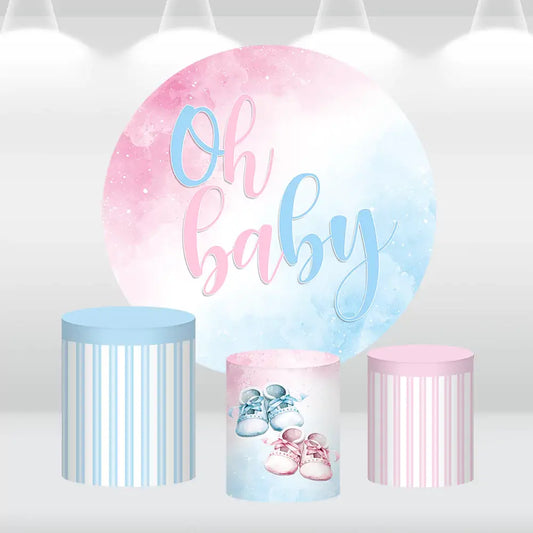 Oh Baby-themed pink and blue round backdrop with matching cylinder covers for baby showers and gender reveal parties.