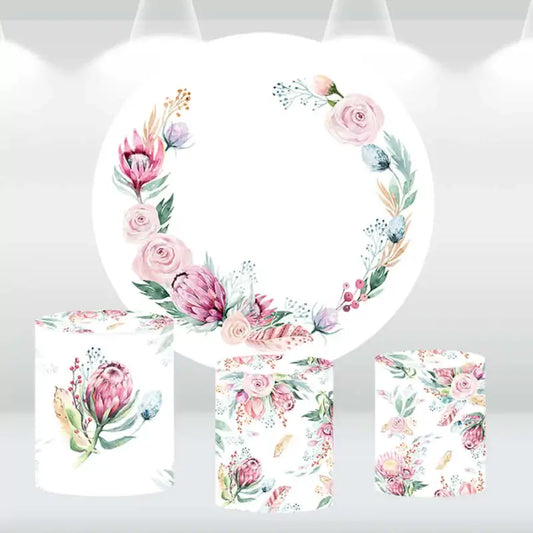 Floral wreath-themed round backdrop with matching cylindrical pedestal covers featuring pastel flower designs, ideal for weddings and baby showers.