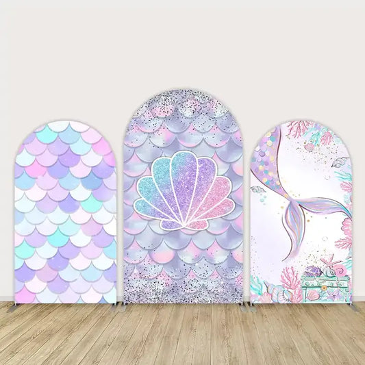Three-panel mermaid party arch backdrop set with pastel iridescent scales, glitter seashell, and a mermaid tail surrounded by coral and ocean details.