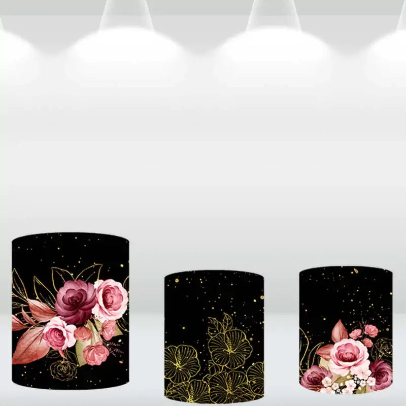 Three matching cylindrical covers with floral and gold patterns, designed to complement a luxurious 'Meus 15 Anos' floral-themed round backdrop.