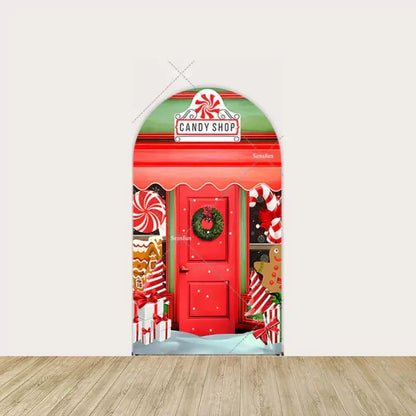 Red door with wreath, peppermint swirls, and gingerbread house decorations.