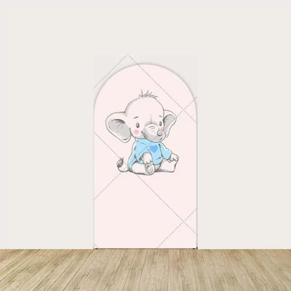 Center arch panel with a sitting baby elephant wearing a blue onesie with a heart on a pale pink background.