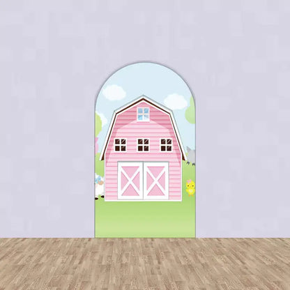 Center arch featuring a large pink barn with white doors and windows – a sweet and simple farm party background centerpiece.