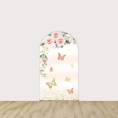Arch panel with cascading pink and white roses, gold and pink butterflies, and soft blush ombré background—romantic Sweet 16 party decor.