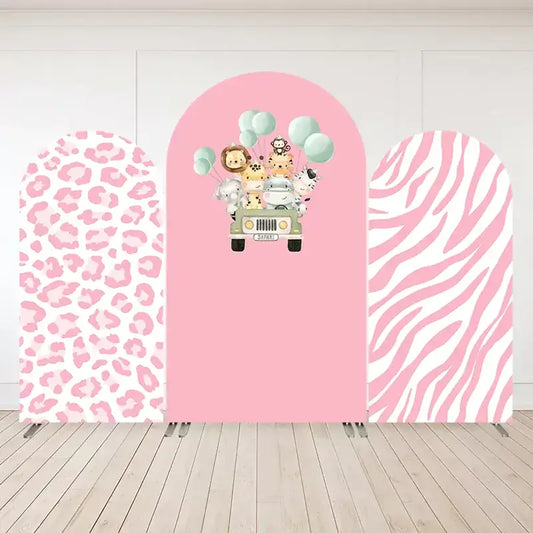 Three-panel pink safari-themed arch backdrop with a jeep full of jungle animals, pastel balloons, pink leopard print, and pink zebra print panels.