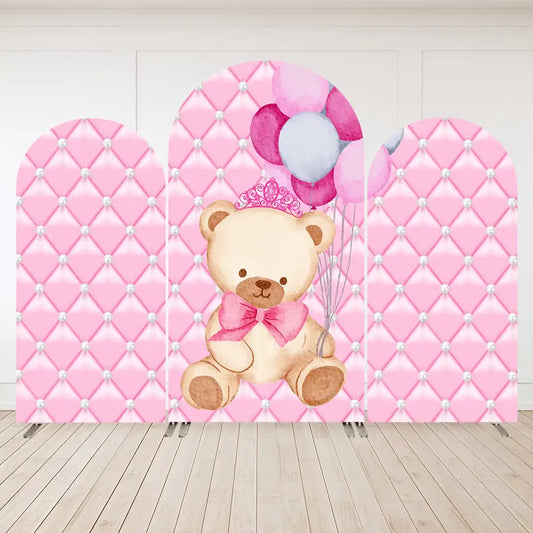 Three-panel pink party arch backdrop featuring a teddy bear with a bow and tiara holding balloons, set against a pink diamond-quilted background with pearls.