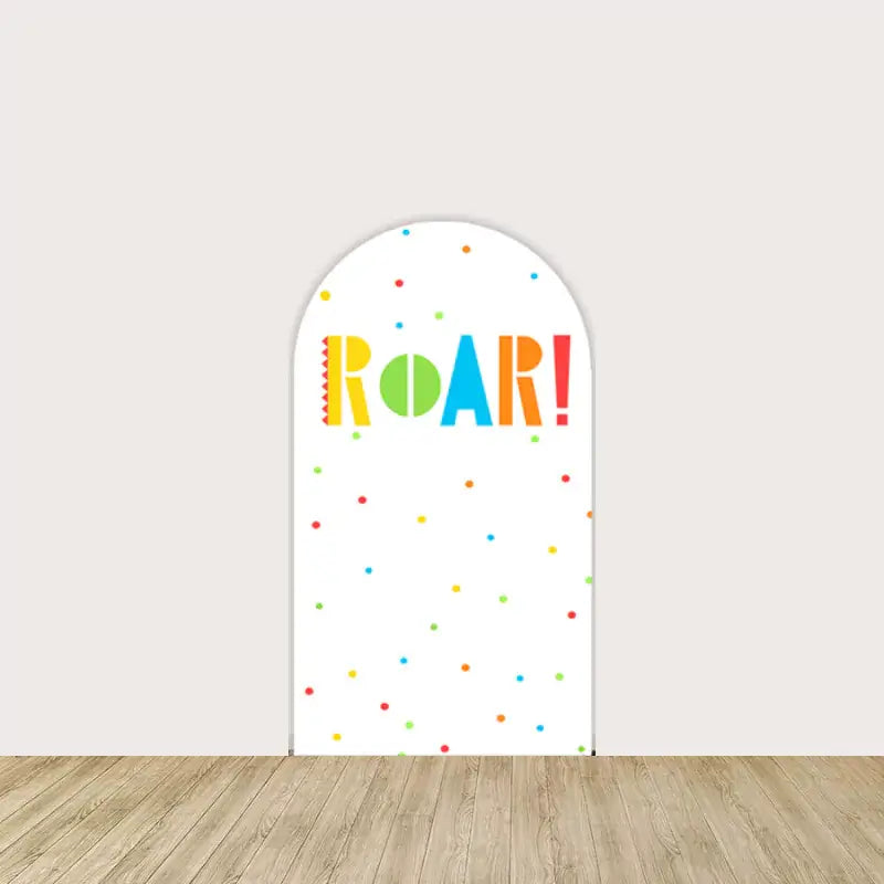 White backdrop with vibrant "Roar!" text and colorful polka dots, adding a playful and fun element to the dinosaur party decor.