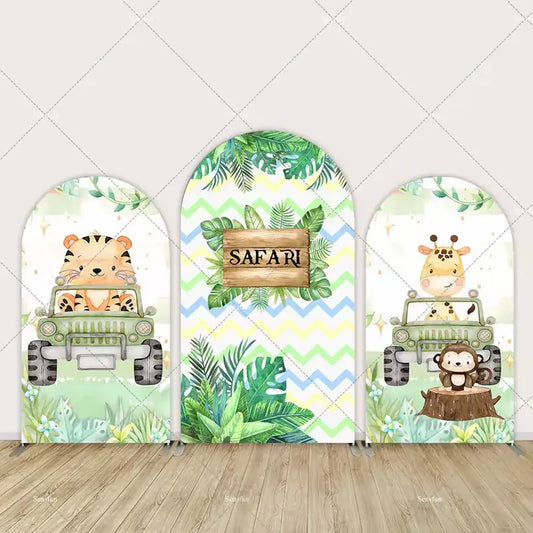 Safari-themed party backdrop with tropical plants, a tiger and giraffe in safari jeeps, and playful jungle decor