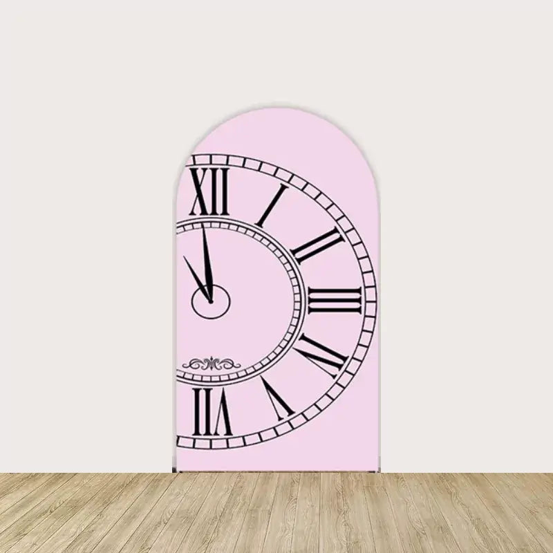 Pink arched backdrop with a vintage-style clock face showing Roman numerals, adding a whimsical Wonderland touch to event decor.