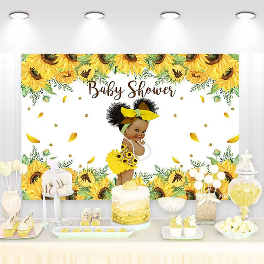 Baby shower backdrop with African American baby girl in yellow sunflower dress and floral accents.