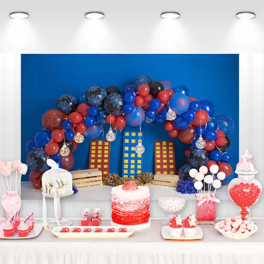 Superhero-themed birthday party backdrop with a cityscape and colorful balloons, perfect for kids' events.