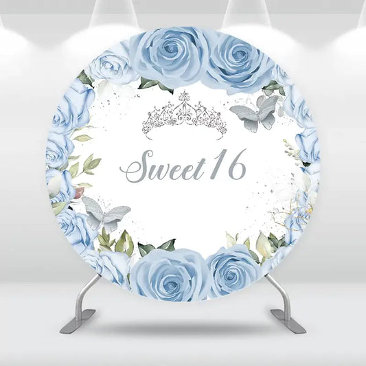 Sweet 16 birthday backdrop featuring blue roses, a crown, and butterflies – elegant floral design for a dreamy party celebration