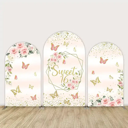 Three-panel Sweet 16 arch backdrop with blush pink background, gold glitter, butterflies, and roses—elegant and feminine birthday party decor.