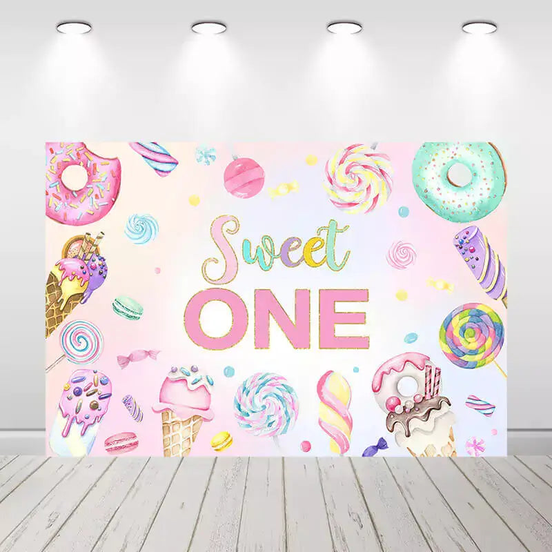 Sweet One birthday party backdrop with pastel colors, donuts, ice cream, lollipops, and candies – perfect for a dessert-themed first birthday celebration
