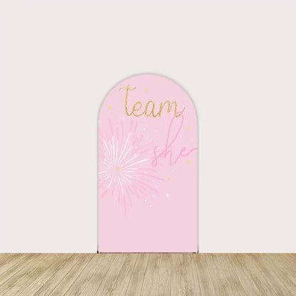 Arch panel featuring “Team She” in gold script, pink fireworks, and sparkles—perfect for baby showers and gender reveal events.