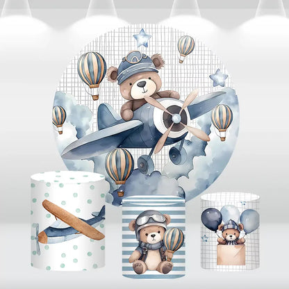 Teddy bear pilot-themed round backdrop with hot air balloons and matching cylinder covers, perfect for kids’ birthday parties and aviation-themed events.