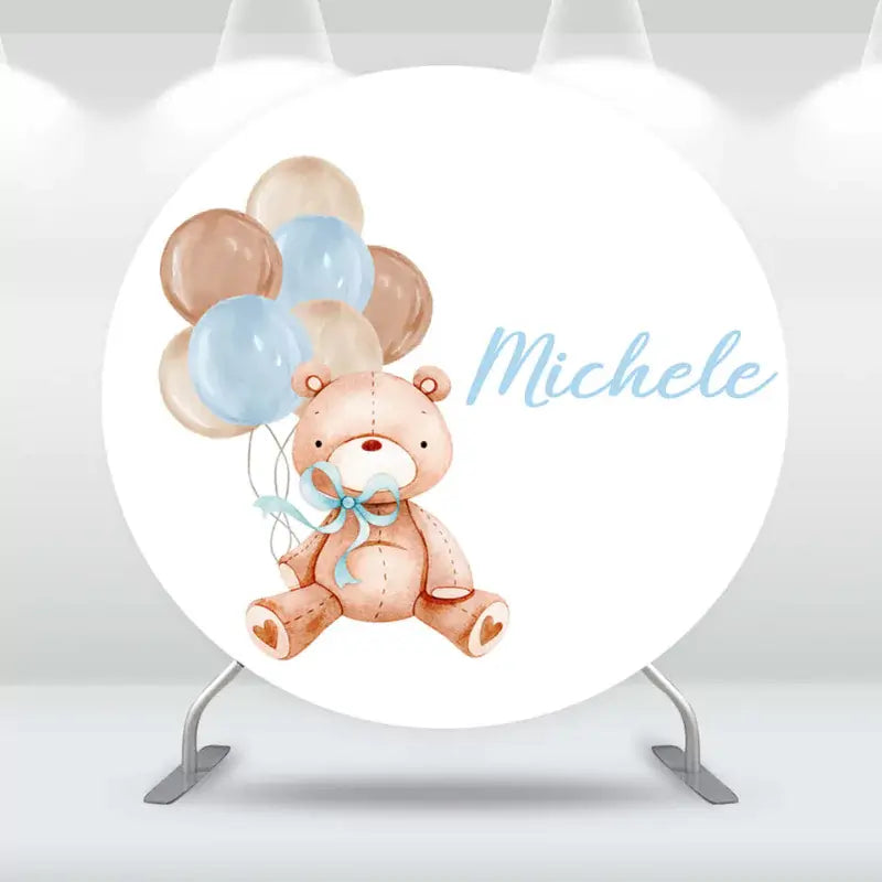 Personalized baby shower backdrop with teddy bear and blue balloons.