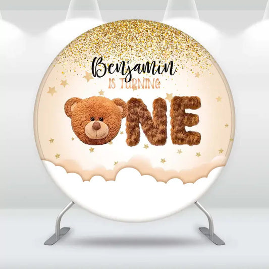 Cute teddy bear first birthday backdrop for Benjamin with golden stars and the word 'ONE' in fuzzy letters.