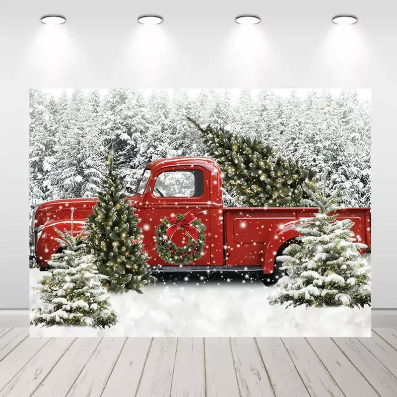 Vintage red truck Christmas backdrop with snow and Christmas trees, perfect for holiday party decor.