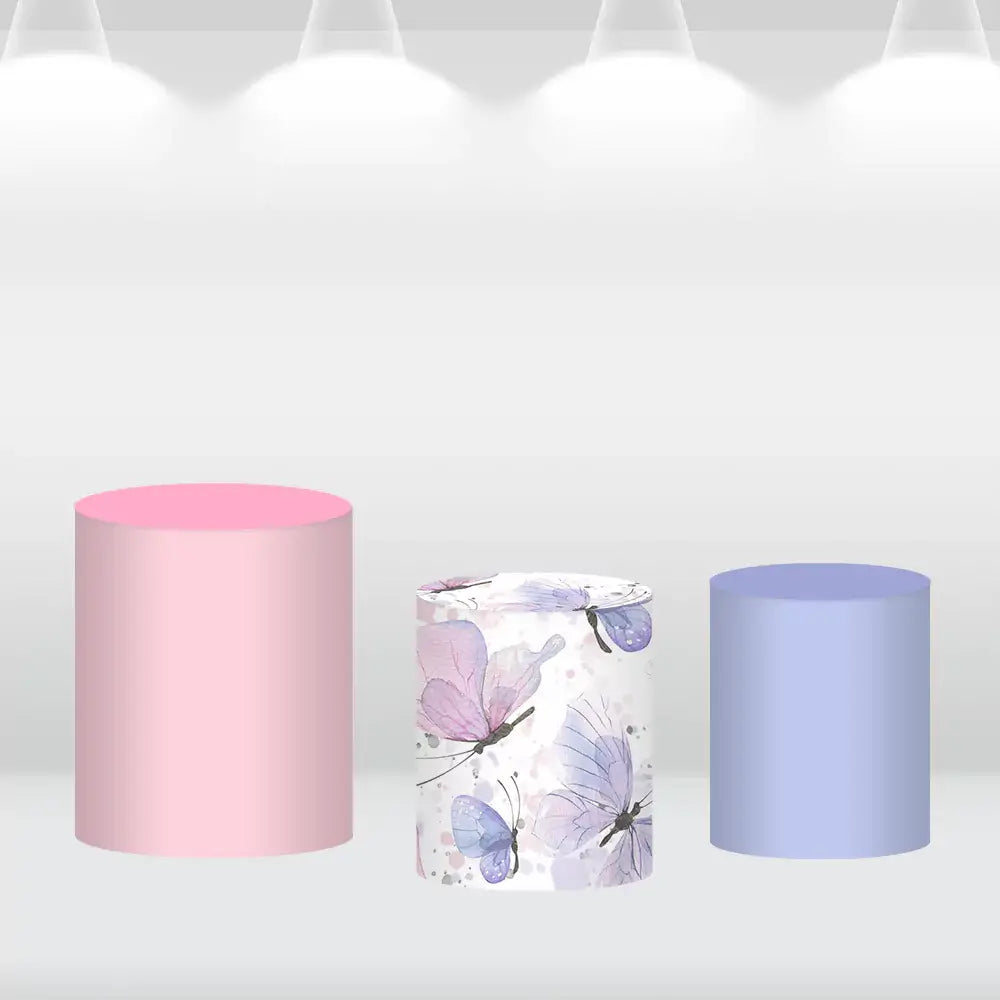 Set of three cylinder covers, including solid pastel pink and purple designs, and a butterfly-patterned cover with watercolor butterflies, complementing the round backdrop.