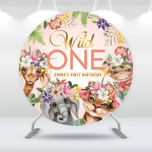 Wild One birthday backdrop for Emma's first birthday featuring cute jungle animals with floral crowns on a soft peach background.